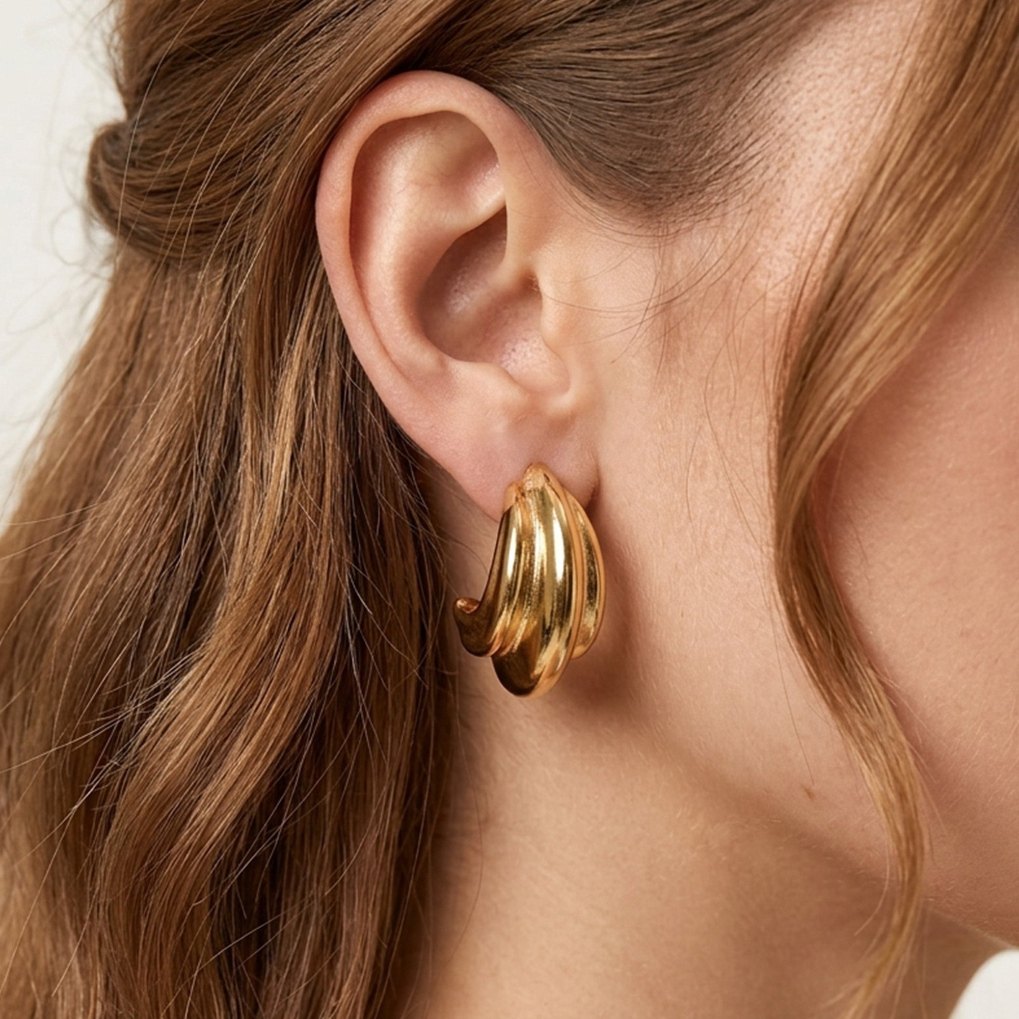 Gold stainless steel earrings collection — Vera chunky hoops on model — Tamola Jewellery