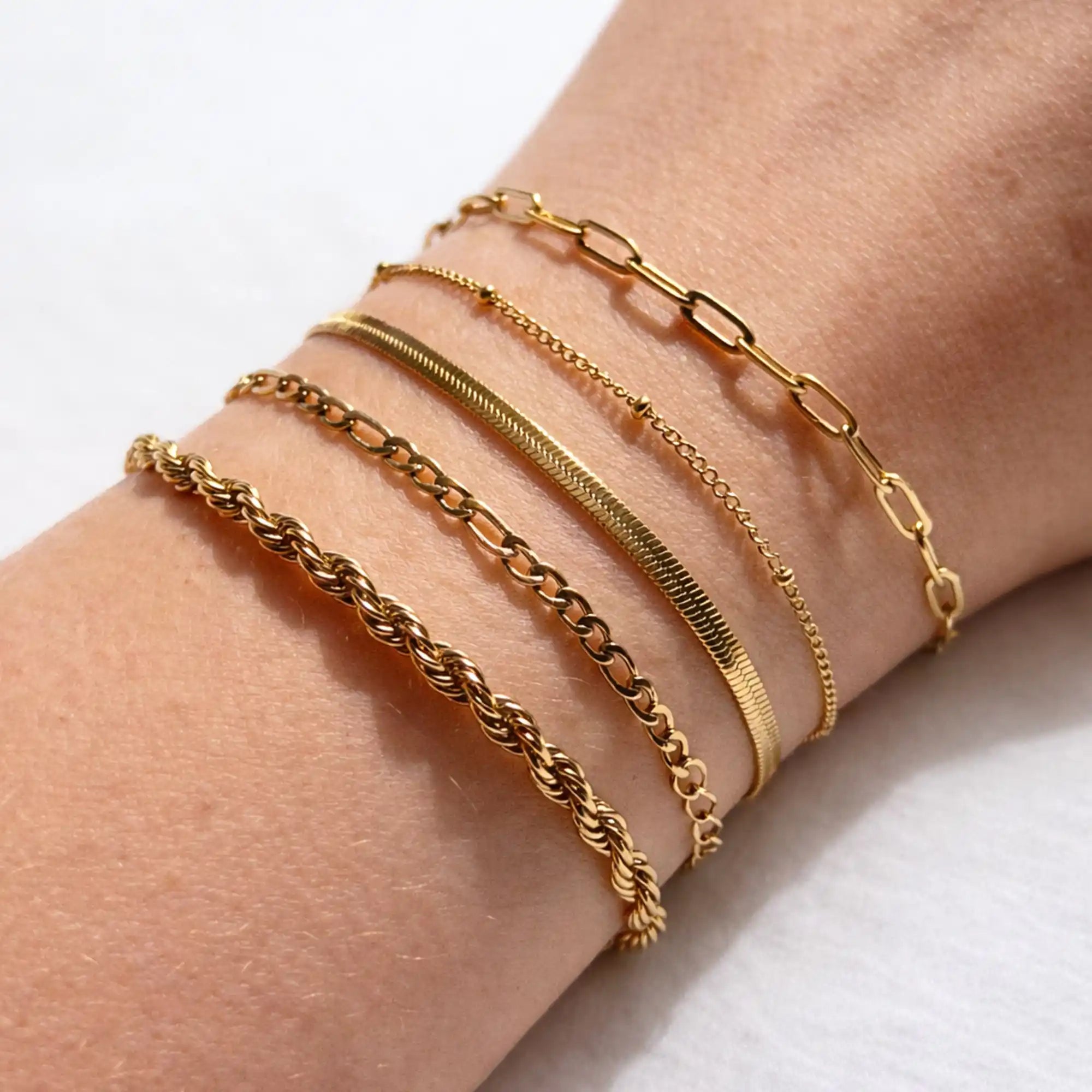 Gold Essential Bracelet Pack five bracelets laid flat stainless steel — Tamola Jewellery